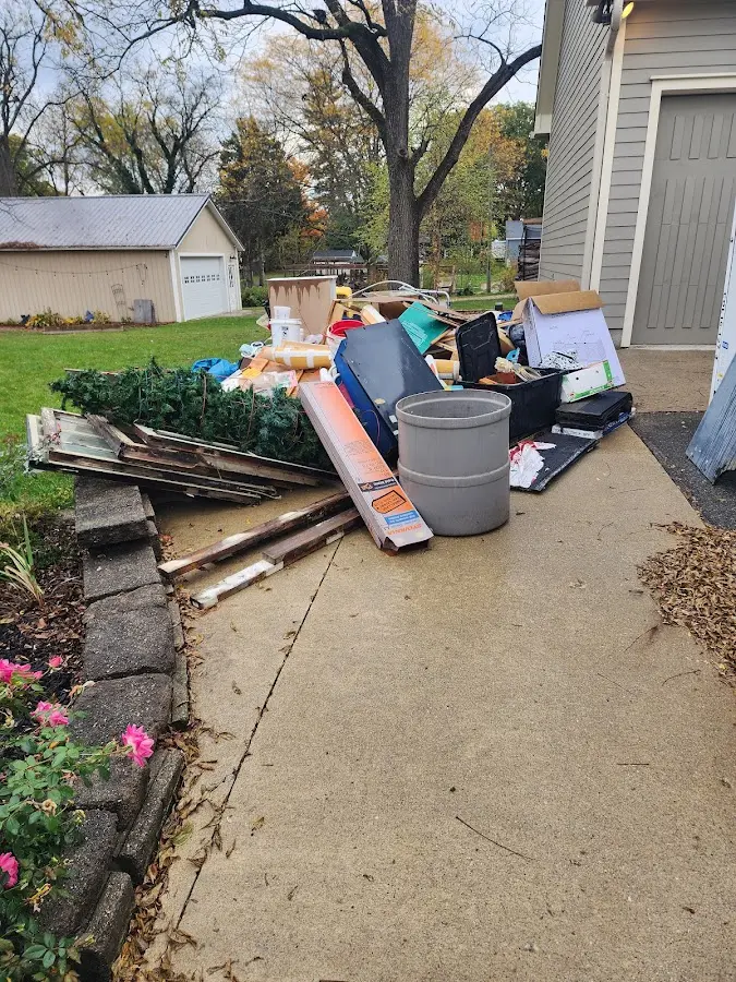Dumpster being loaded with debris for Roofing Dumpster Rental in Medford
